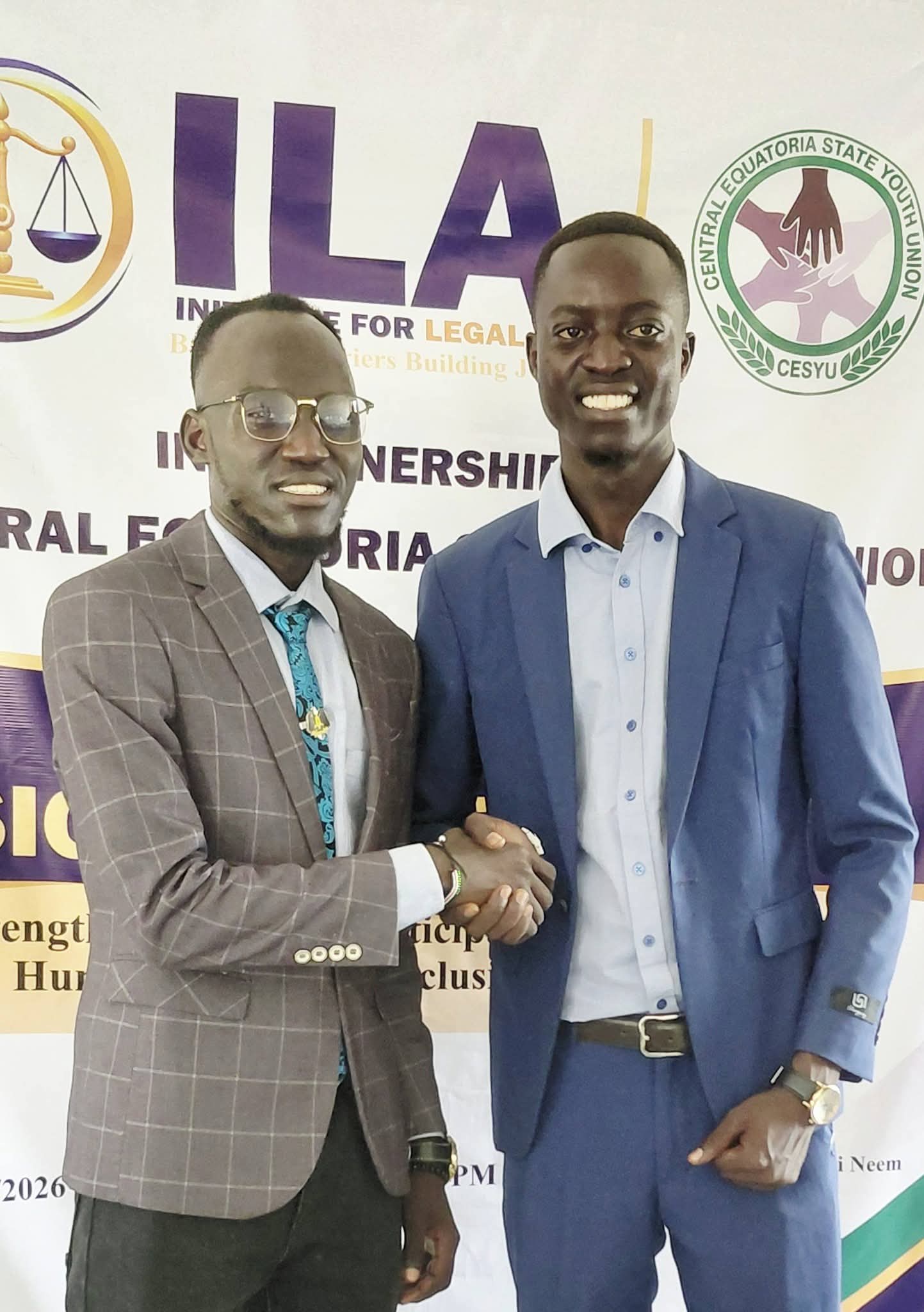 Representatives of ILA and CESYU shake hands at the partnership signing ceremony.