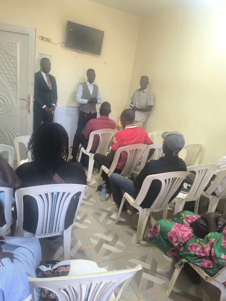 ILA staff addressing seated participants during a community legal awareness session.